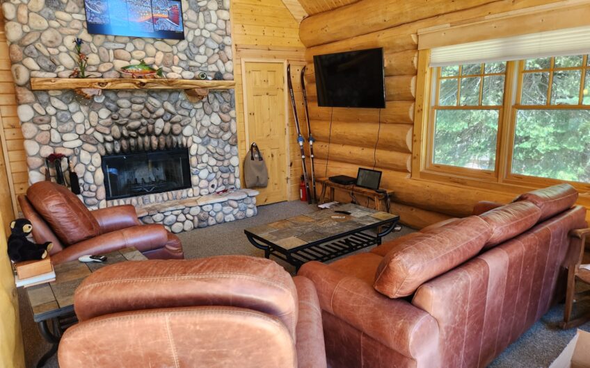 Log Home in a field of Aspen